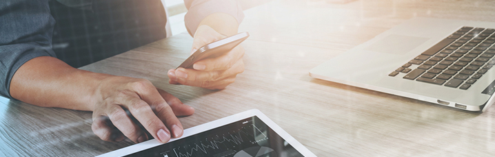Person working at multiple screens