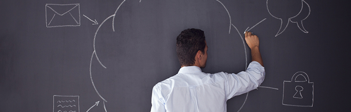 Mna writing at a chalk board
