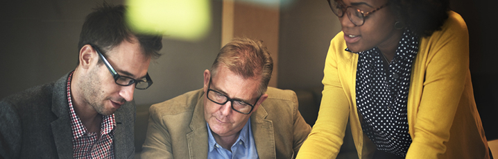 Team huddled around a computer