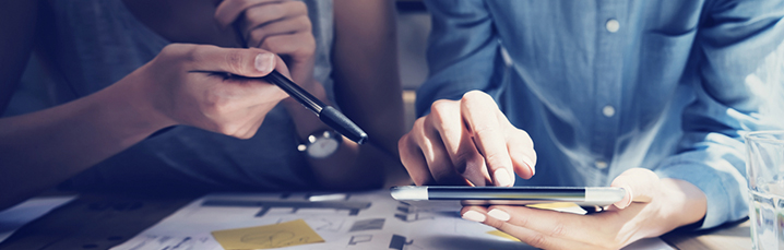 Team reviewing tablet screen