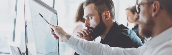 Team looking at computer screen