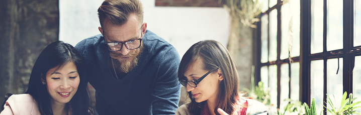 Team huddled around a laptop screen