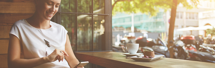 Person in a cafe working from a smartphone