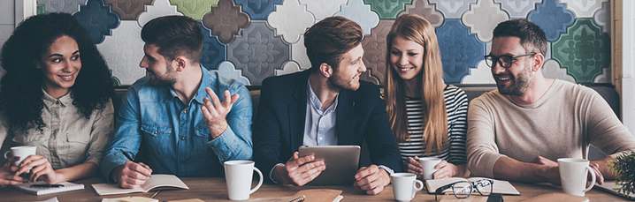 Happy casual team meeting in a coffee shop